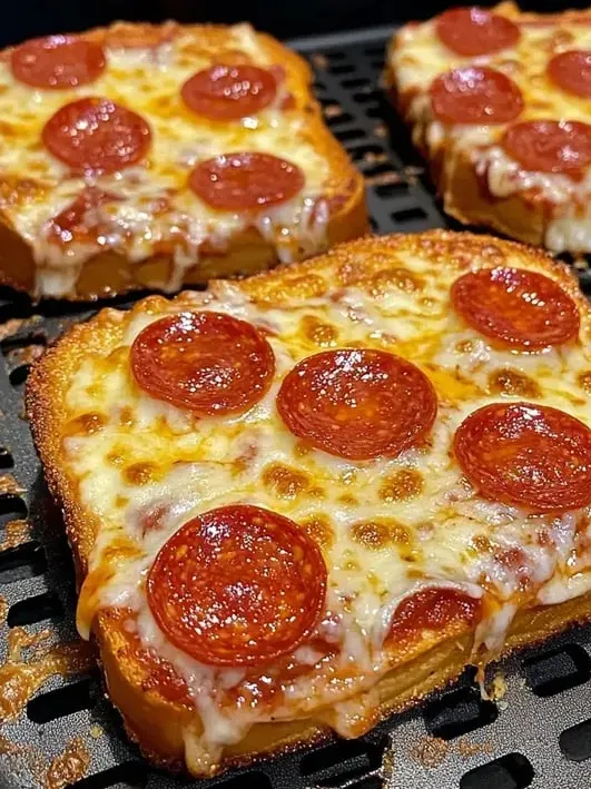A pepperoni pizza slice sitting on a grill rack.