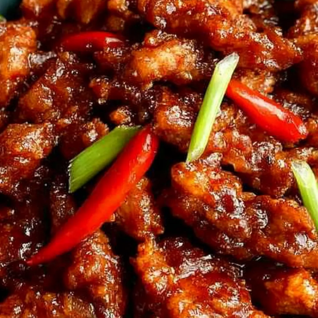 A big serving of chicken and peppers on a plate.