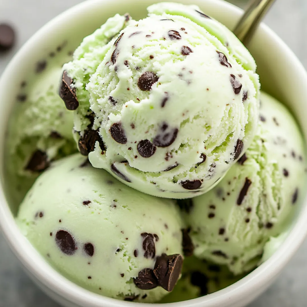 A bowl packed with minty ice cream and chocolaty flecks.
