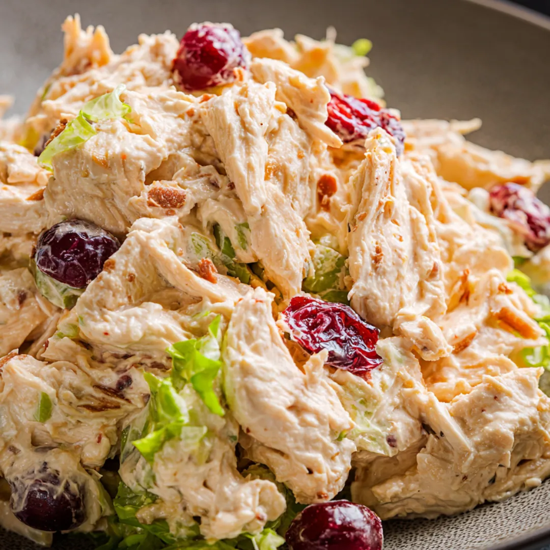 A dish with meat and salad sitting together.