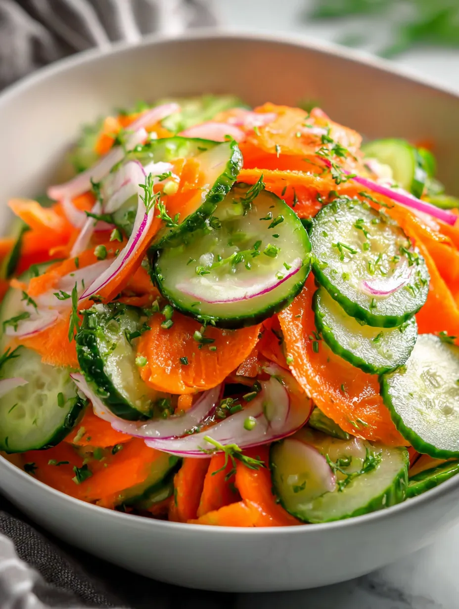 A bowl packed with cucumbers and carrots.