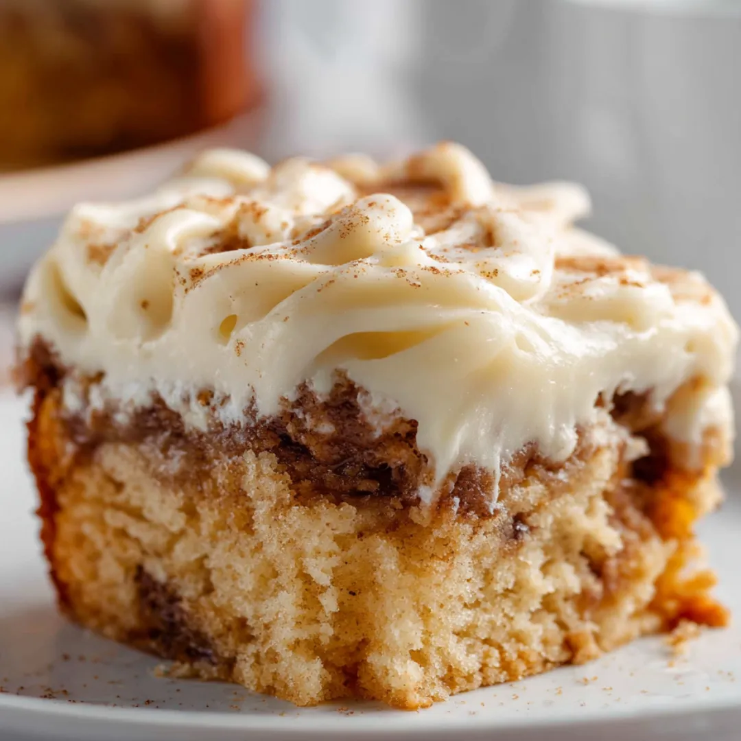 There’s a piece of cake covered in white frosting.
