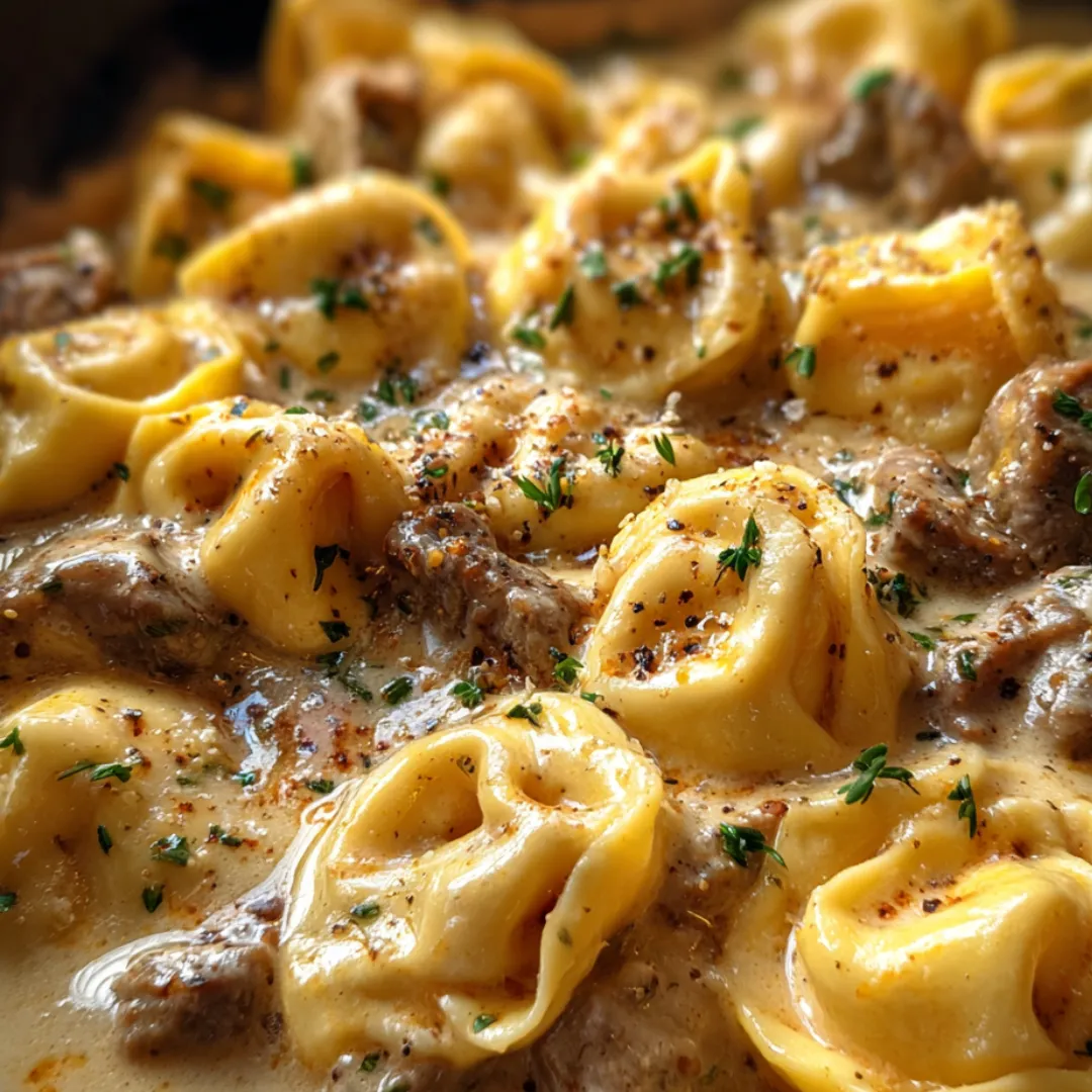 Creamy pasta with beef and cheese in a bowl.