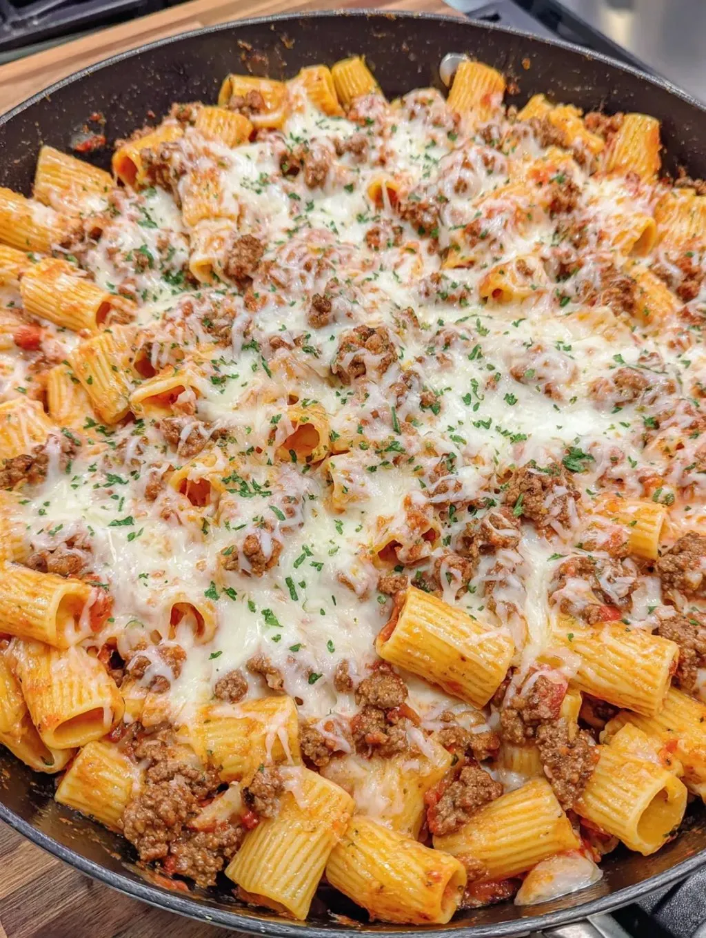 A plate of pasta with meat and cheese.