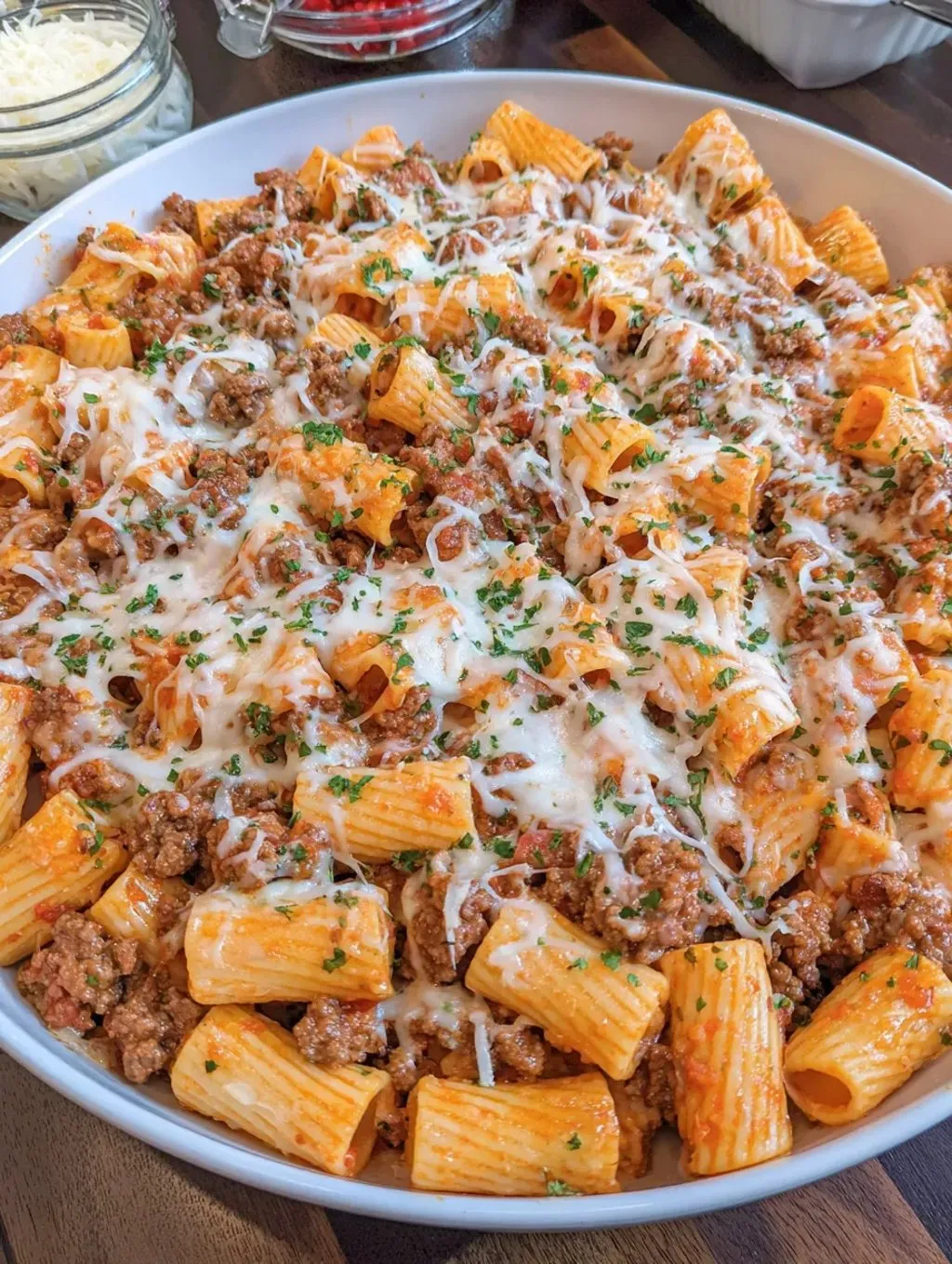 A bowl of pasta with meat and cheese.