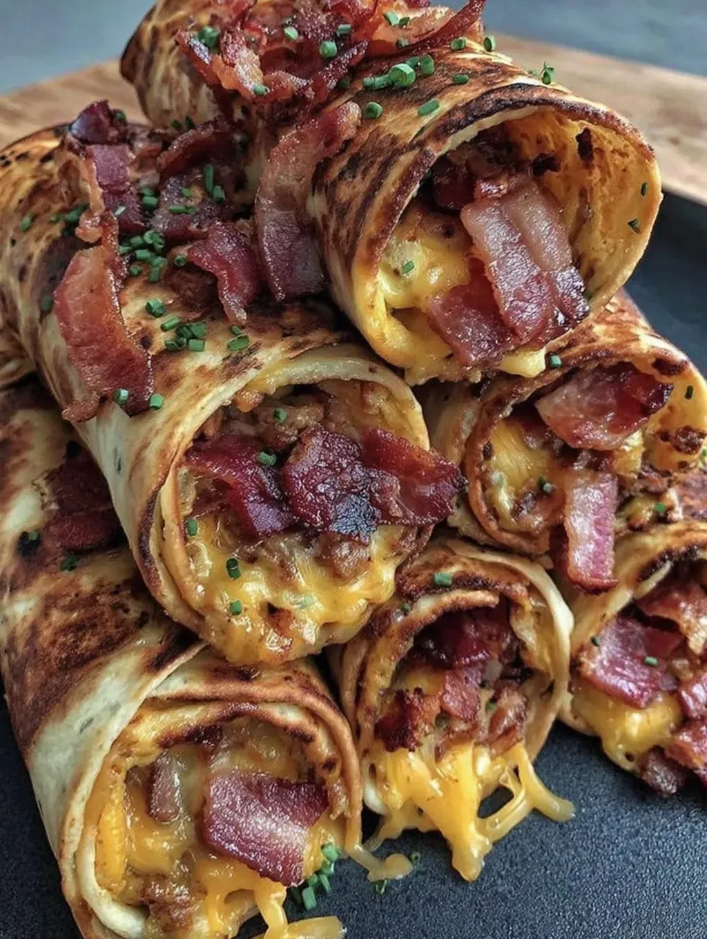 A stack of bacon wrapped sandwiches.