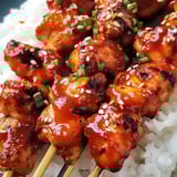 A dish of chicken sticks with dipping sauce.