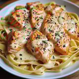 A plate of food with fish and pasta.