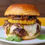 Burger topped with grilled pineapple ring.