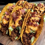 A plate loaded with cheesy bacon tacos.