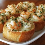 Shrimp and cheese piled on crusty bread.