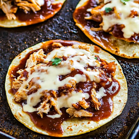 A plate stacked with cheesy chicken tostadas.